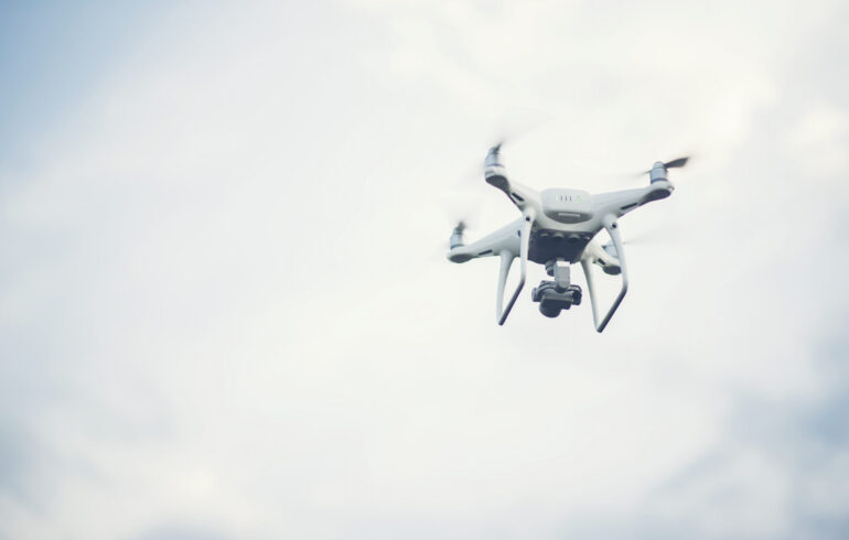 Flying drone up to blue sky background